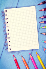 Vintage photo, Colorful crayons and notepad on boards, school accessories, copy space for text