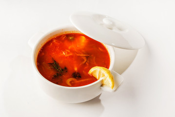 Solyanka mix soup with sausages, olives and lemon