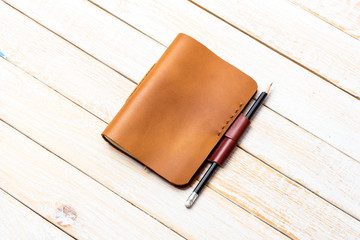 Brown Leather notebooks with on white wooden background