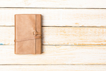 Leather diary notebook on white wooden background, Business temp