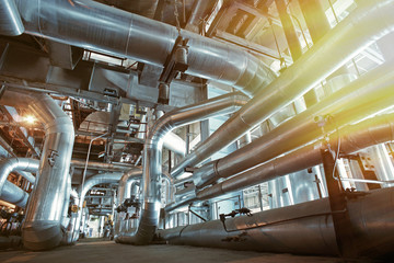 Equipment, cables and piping as found inside of a modern industr