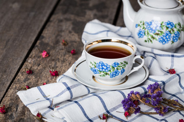 Obraz na płótnie Canvas still life with tea cup and tablecloth on wooden table