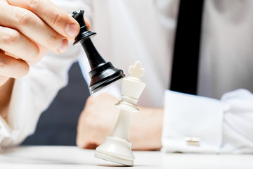 Hand of businessman playing chess