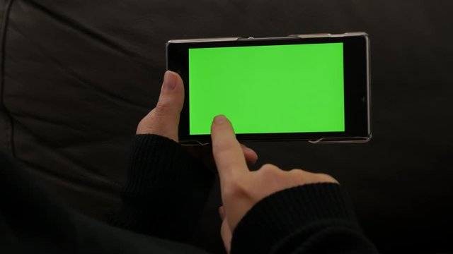Scrolling on mobile phone green screen display 4K 2160p UHD video - Woman holding smart phone with green screen display 4K 3840X2160 UHD footage 
