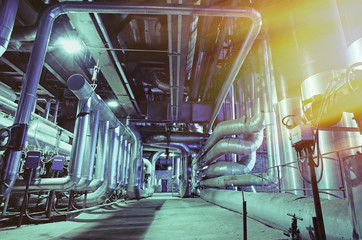 Equipment, cables and piping as found inside of a modern industr