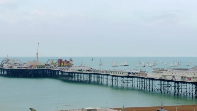 View of many sailing boats in a race around Brighton beach