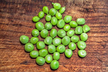 green peas on wooden background