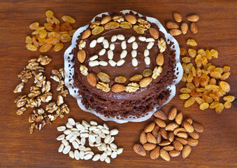 Obraz na płótnie Canvas New Year 2017 homemade cake decorated with nuts and raisins on a cutting board