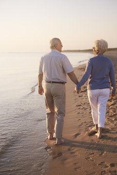 Senior couple walking hand by hand