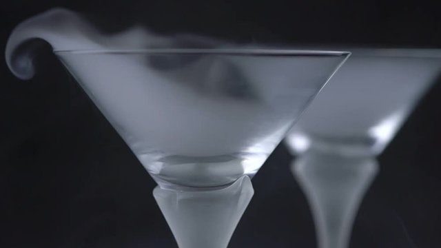 White smoke in cocktail glass on a black background
