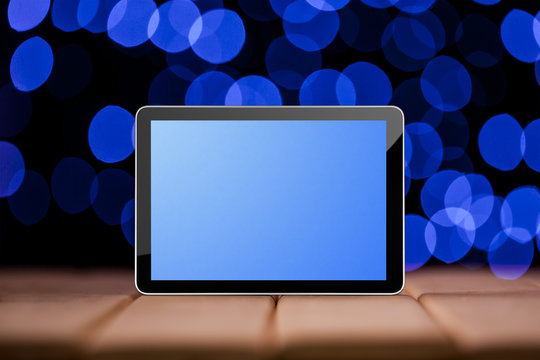 Tablet on the green bokeh backrounds.