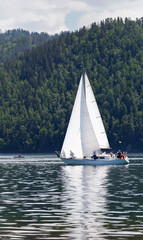 Single-masted sailing yacht in the source of the Angara River