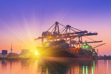 Cargo ship terminal at twilight scene, Unloading crane of cargo