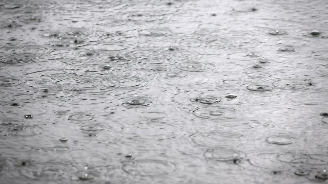 Amazing slow motion nature scene with heavy rain on the water surface. Closeup shot of natural background with meditative and hypnotic effect. Full HD footage 1920x1080
