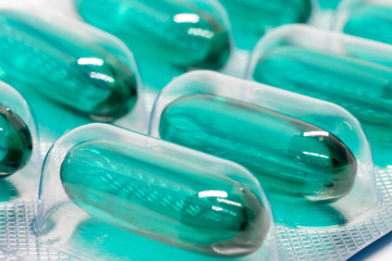 green soft gel capsules pills in blister pack