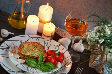 Vegetarian zucchini fritters served with fresh herbs, tomatoes a