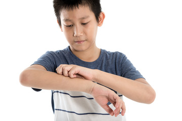 Asian boy scratching his arm on white background.