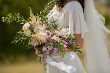 beautiful wedding bouquet in the hands of the bride