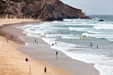 Obraz premium One of the best international schools surfers on the Atlantic coast of the Algarve near the town of Sagres on the beach Amado in the south of Portugal