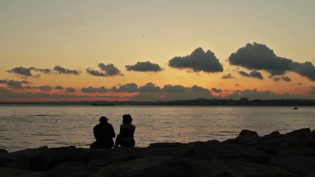 A silhouette of a couple chatting at the water front ,Istanbul 