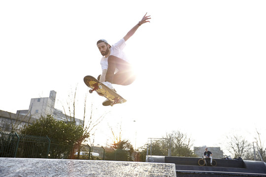 Young man jumping on skateboard