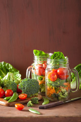 healthy vegetable salad in mason jar. tomato, broccoli, carrot,