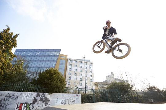 Young man jumping on bmx bicycle
