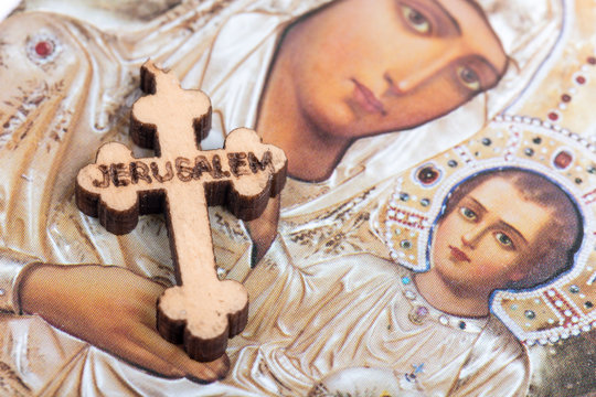 Christian blessed wooden cross and holy mother in background