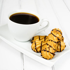 cup of coffee and delicious cakes on a white background