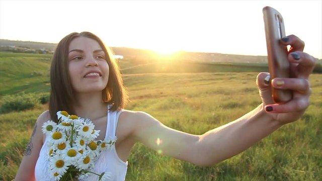 Slow motion Beautiful caucasian woman Make Selfie Bouquet of daisies