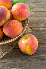 ripe peaches on wooden surface