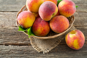 ripe peaches on wooden surface