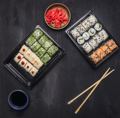 Bento lunchbox Japanese style quick meal that plenty of good nutrition, Various sushi roll with cucumber, salmon and crab on wooden rustic background top view close up