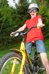 Fototapeta premium Kid on a bike playing super cyclist