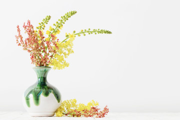 flowers in vase on wooden table
