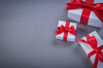 Assortment of wrapped present boxes on grey background holidays 