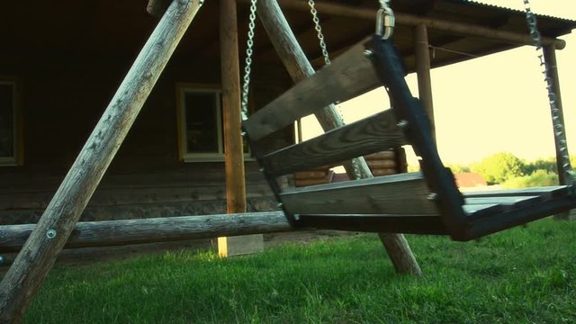 Old swing in the yard with light effect. weirdness