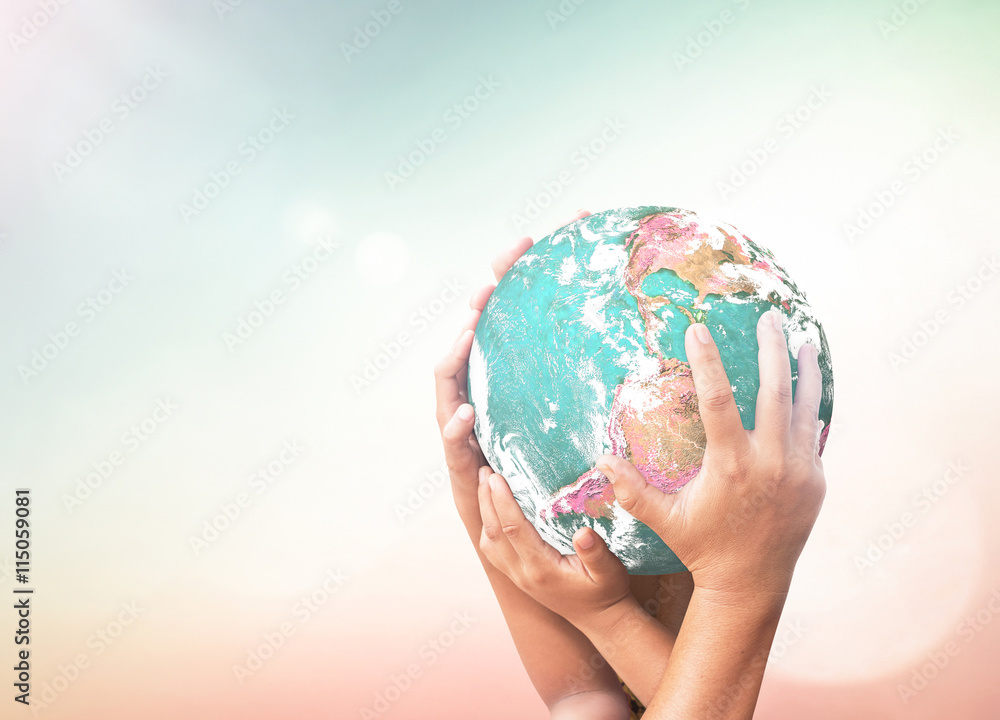 Wall mural earth day concept: earth globe in family hands over blurred nature background. elements of this imag