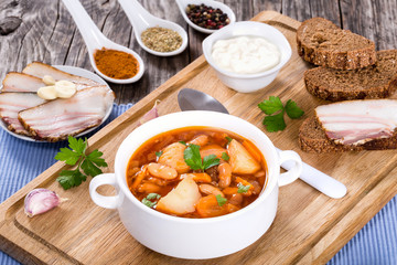 tomato soup in white mug on checkered napkin