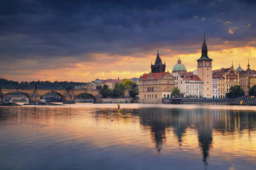 Fototapeta na wymiar Prague. Image of Prague riverside and Charles Bridge, with reflection of the city in Vltava River.