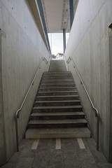 Exiting underground tunnel in the form of a gray concrete stairs