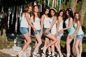 Seven happy and sexy girls on short shorts and white shirts pose