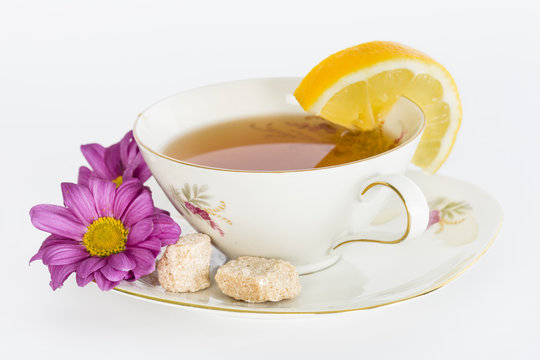 Cup of tea with sugar and slice of lemon