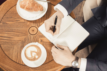 coffee break with a cap of coffee and croisant