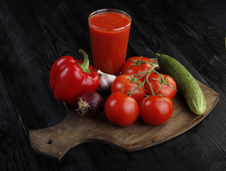 vegetables and tomato juice on wooden background 