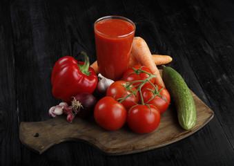 vegetables and tomato juice on wooden background 