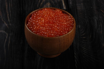 red caviar on wooden background