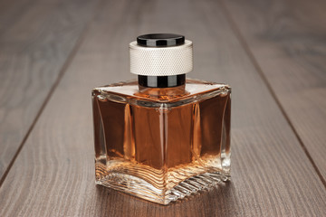 perfume bottle on the brown wooden table background