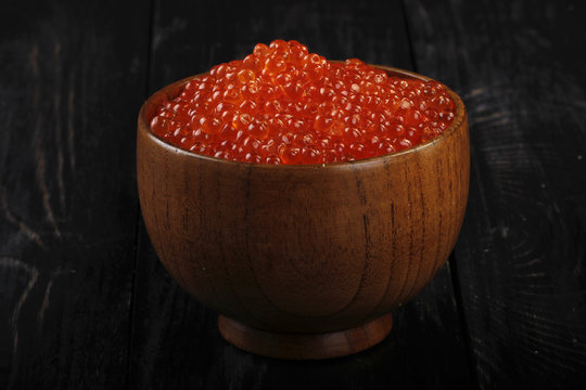 red caviar on wooden background