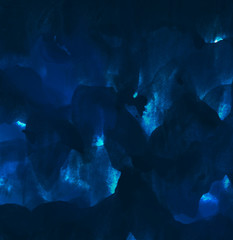 Blue painted background with brush strokes and flow of paint. Vibrant and saturated texture